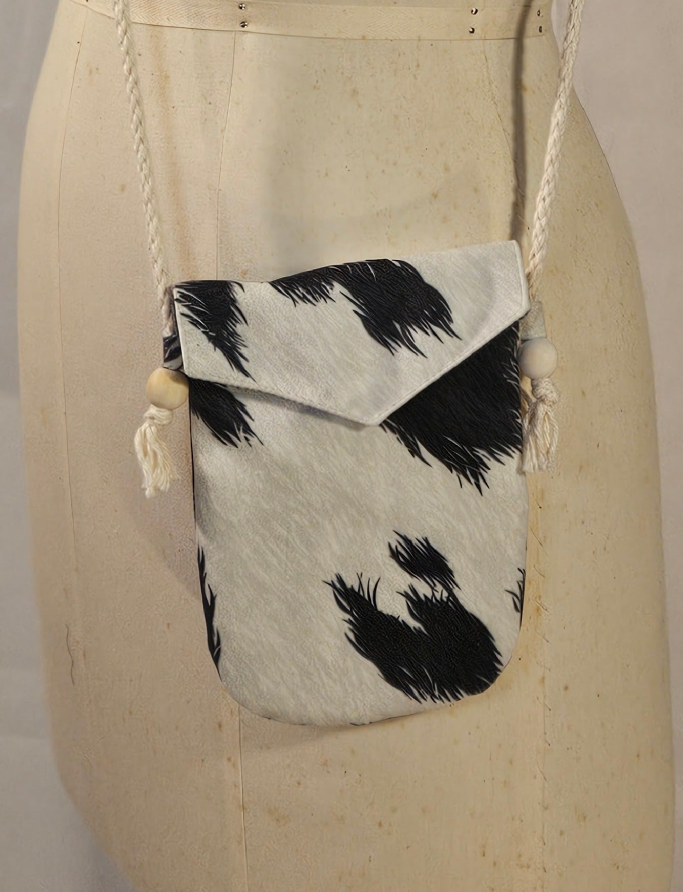 Small pouch with black and white pattern on a mannequin