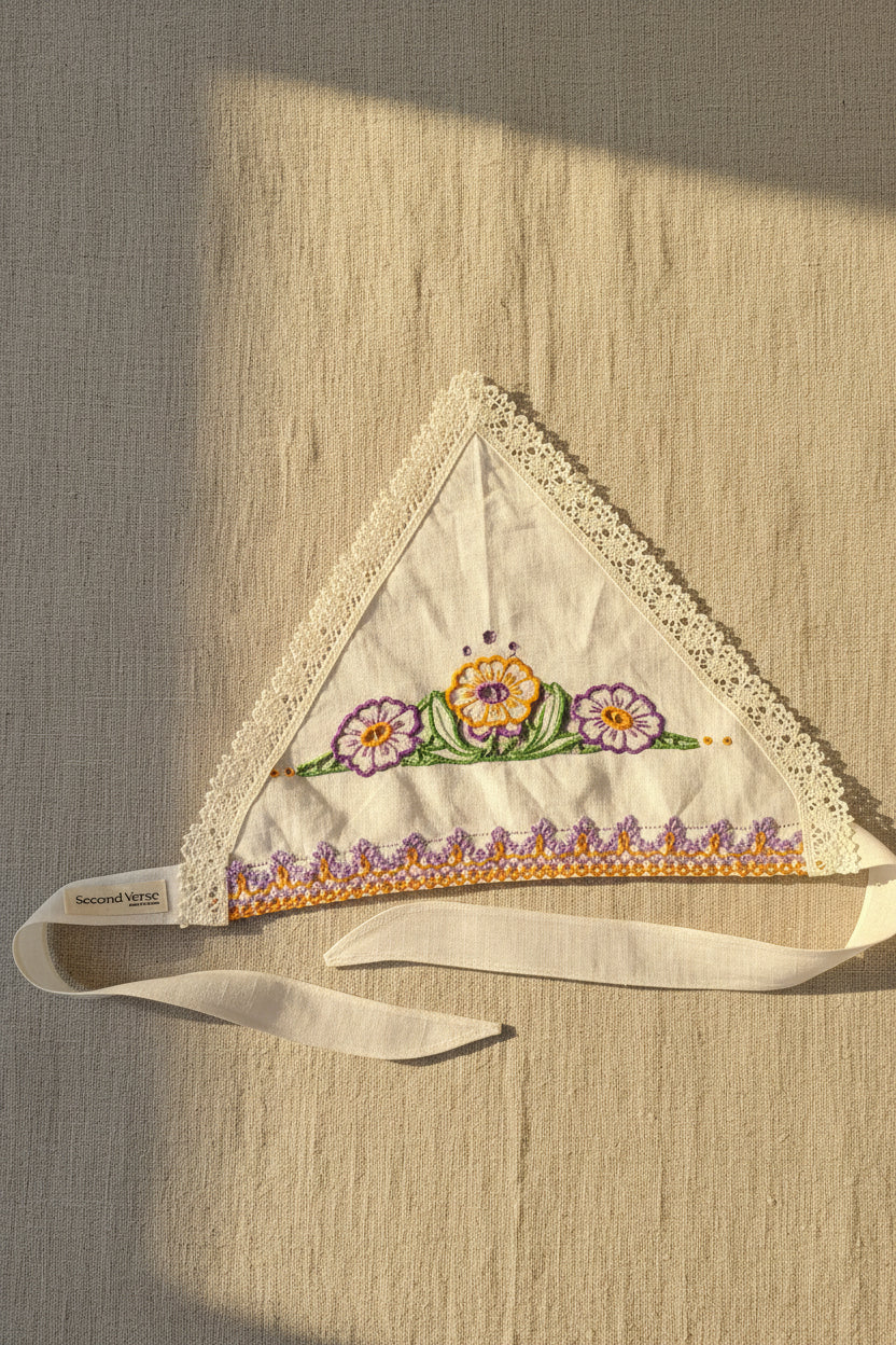 Top View, One-of-two embroidered linen head scarf made from a reclaimed dish towel with floral detail and lace trim.