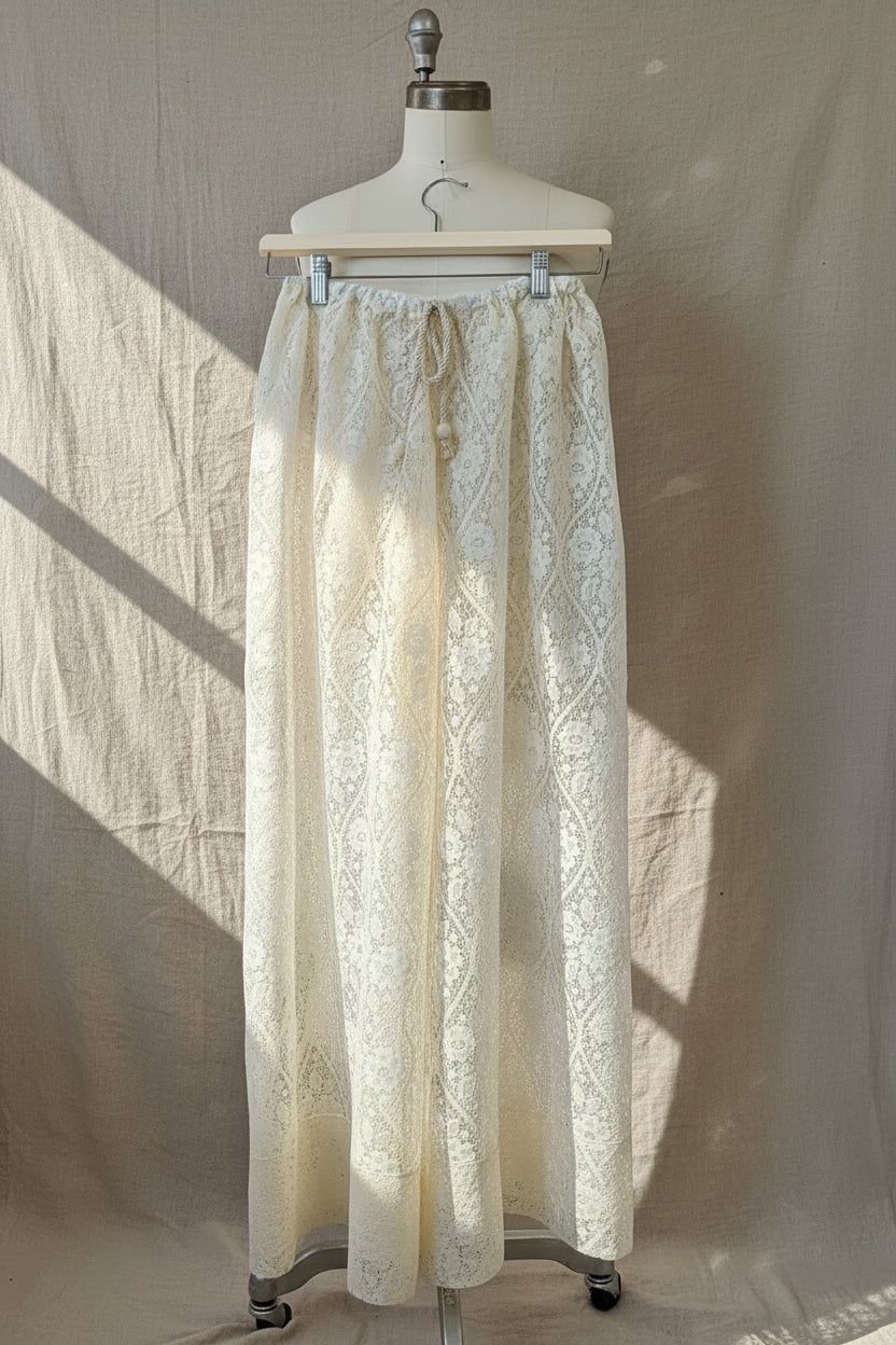 Lace pants on a mannequin against a neutral background