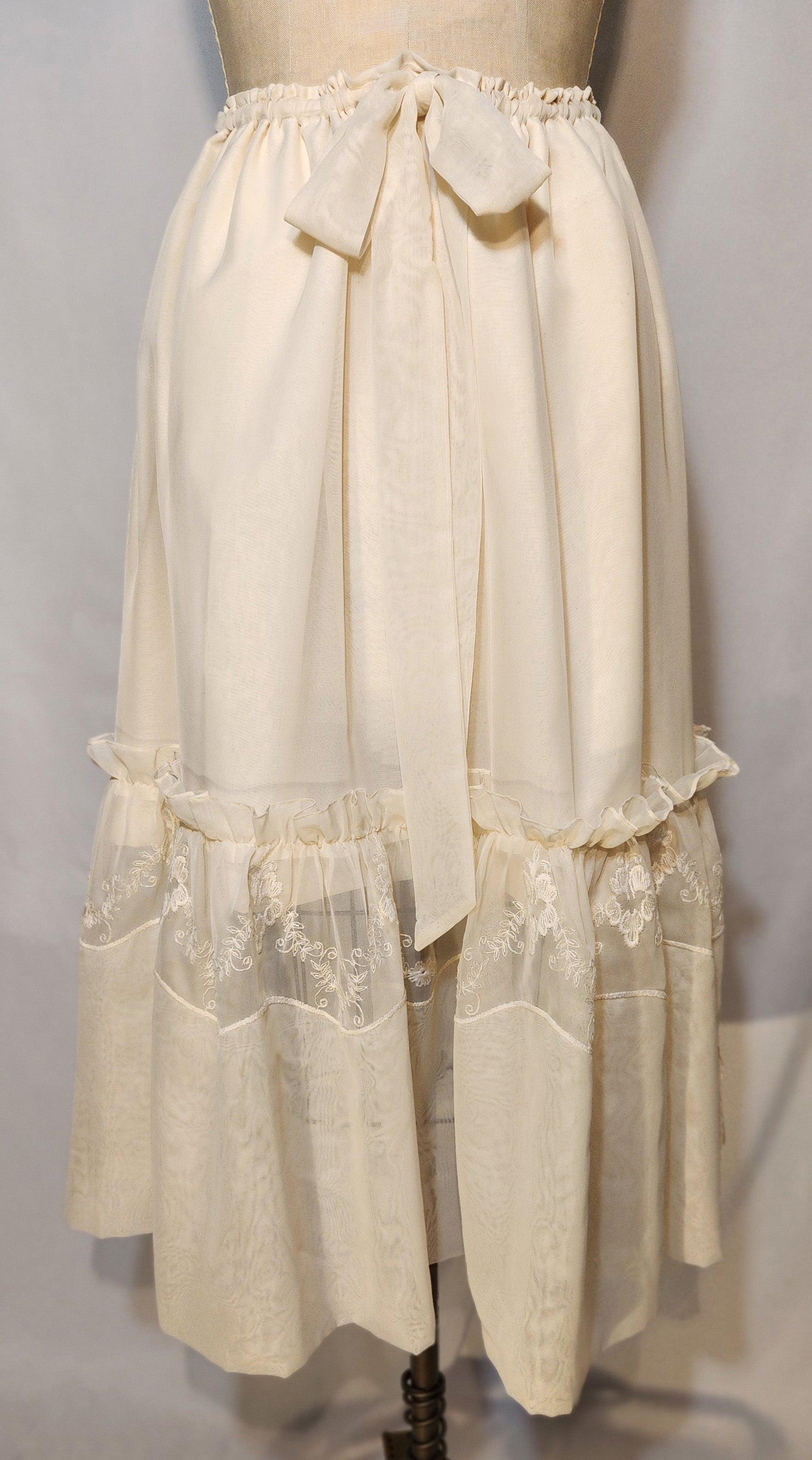 Vintage-style beige petticoat on a mannequin against a plain background