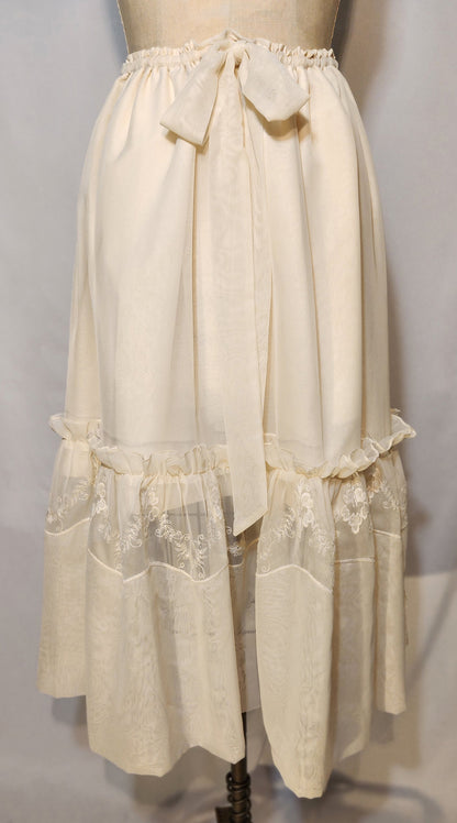 Vintage-style beige petticoat on a mannequin against a plain background