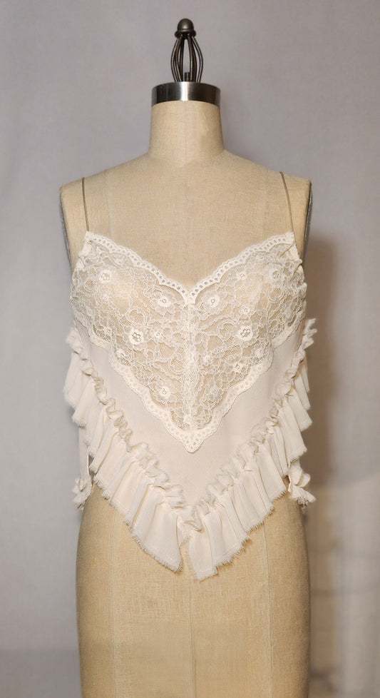 Lace-trimmed top on a mannequin against a neutral background