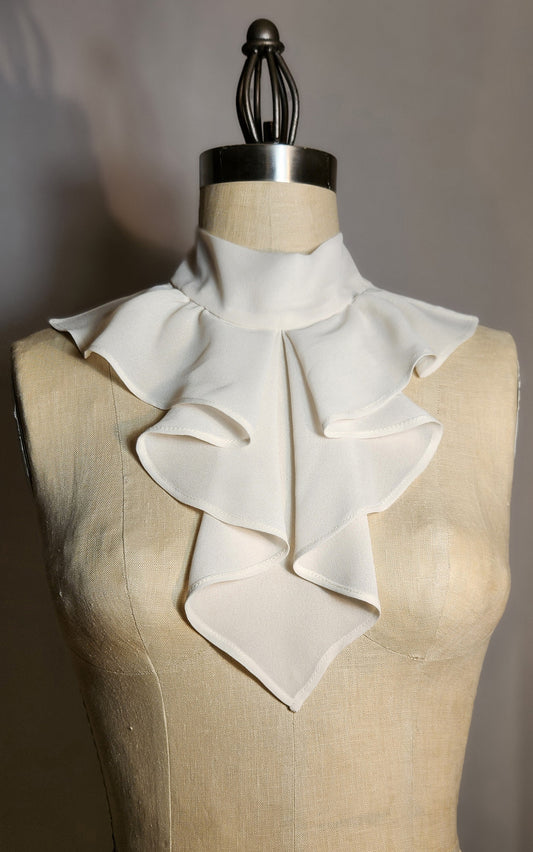 White ruffled collar on a mannequin with a neutral background