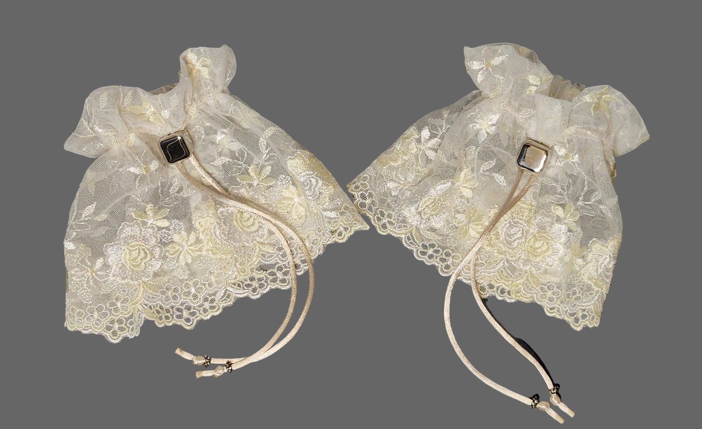 Pair of vintage lace cuffs on a gray background