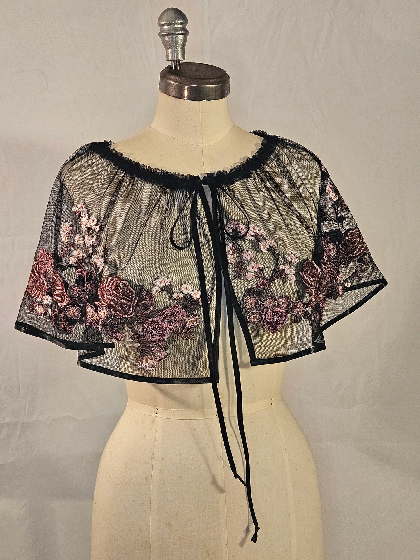 Short black mesh cape with pink floral embroidery