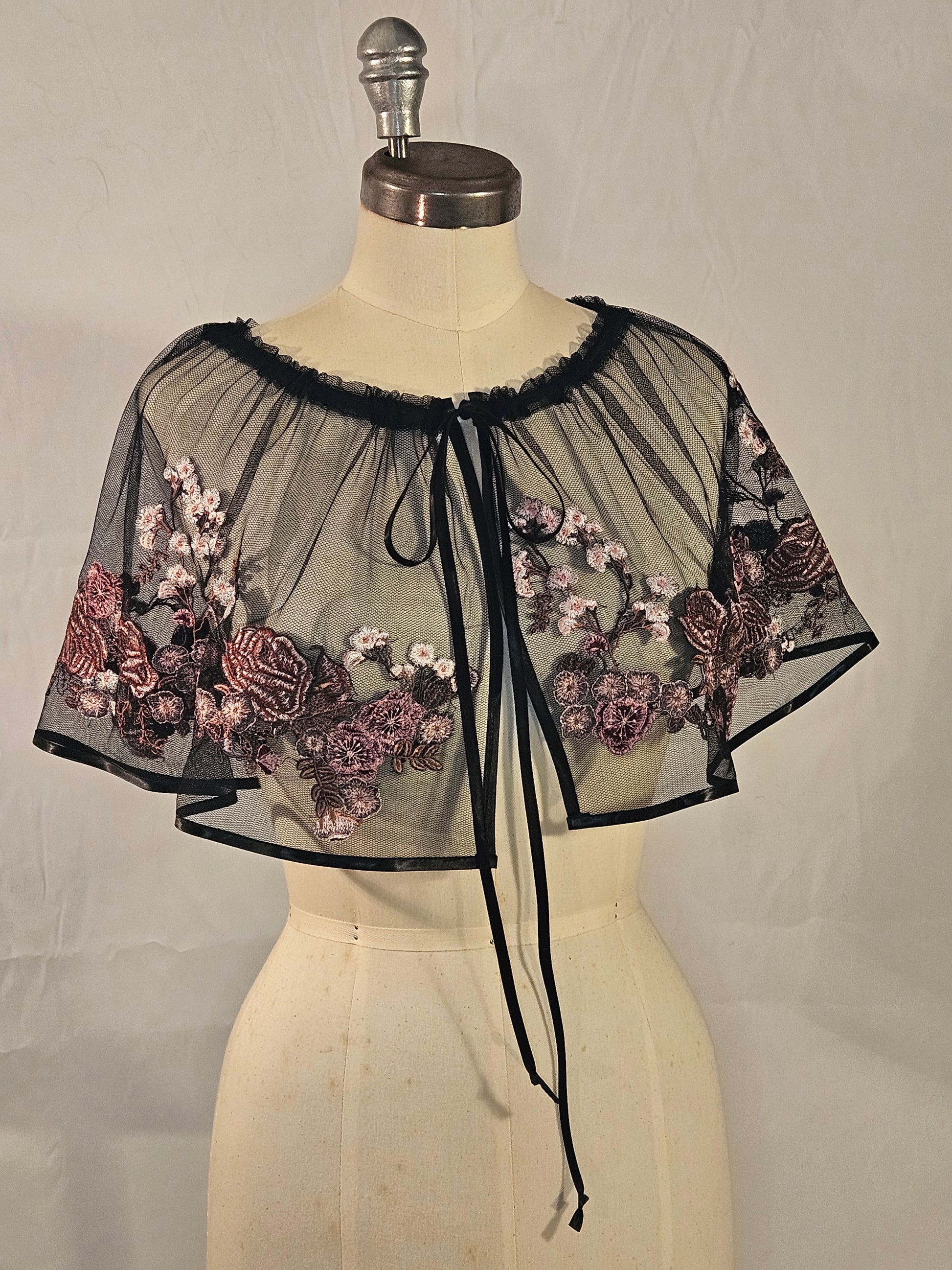 Short black mesh cape with pink floral embroidery
