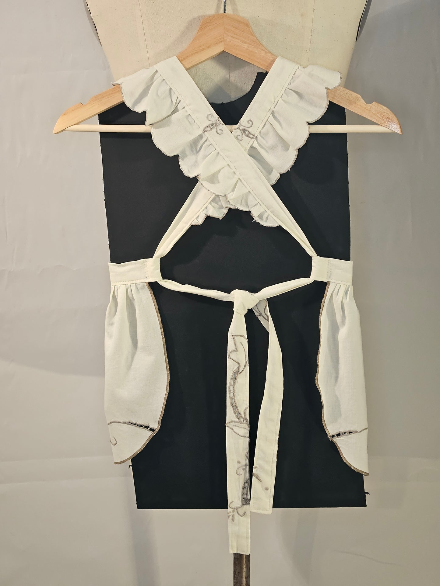 Black and white garment on a mannequin with a neutral background
