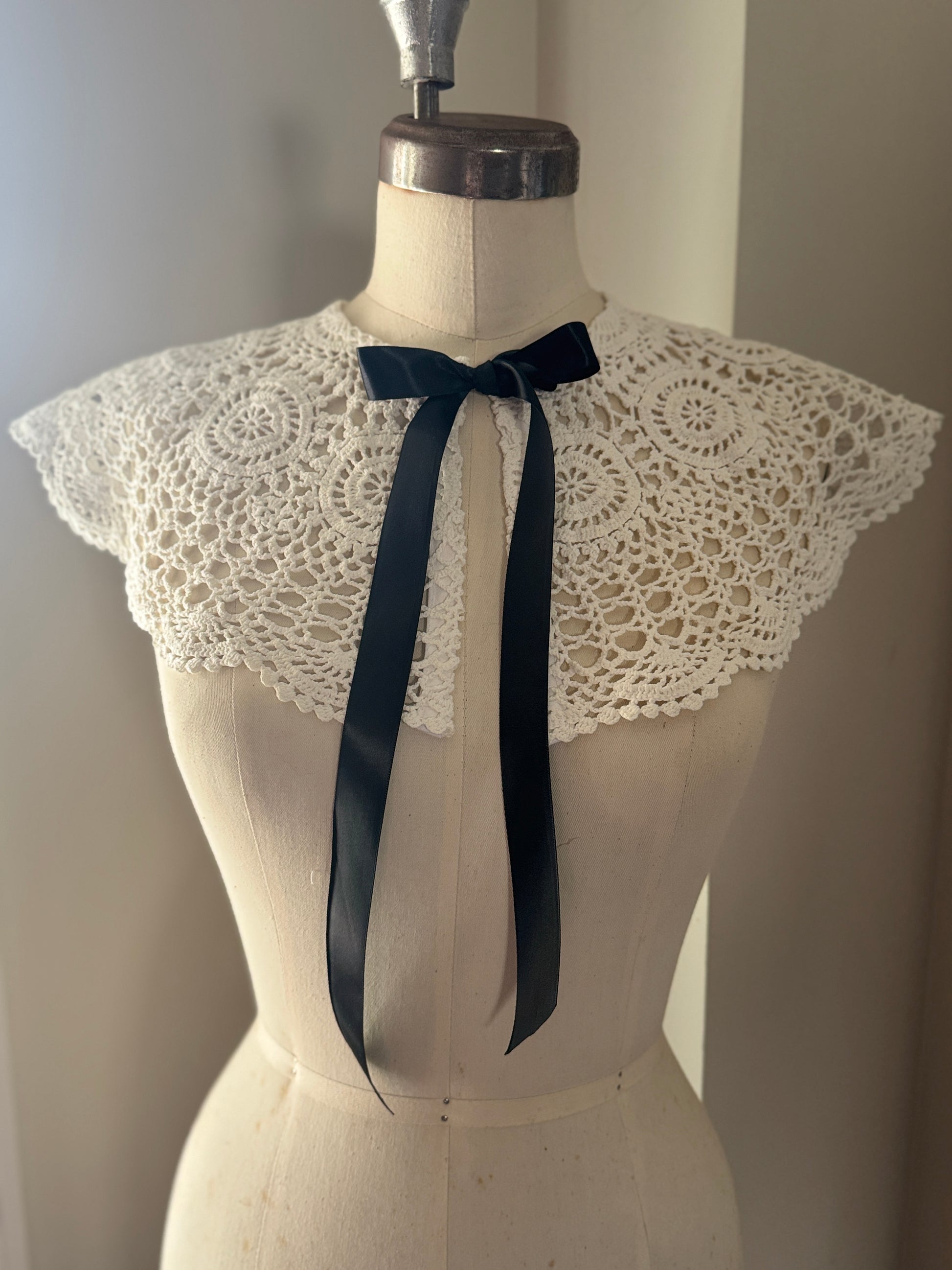 White lace collar with a black satin tie