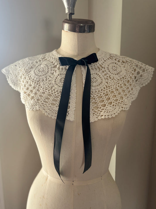 White lace collar with a black satin tie