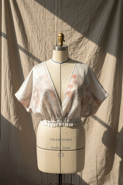 Patterned fabric on a mannequin with dressmaking measurements.