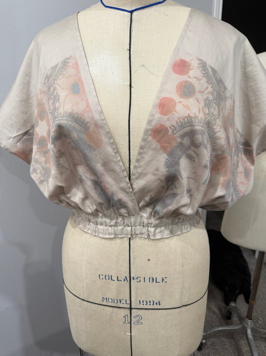 Patterned fabric on a mannequin with dressmaking measurements.