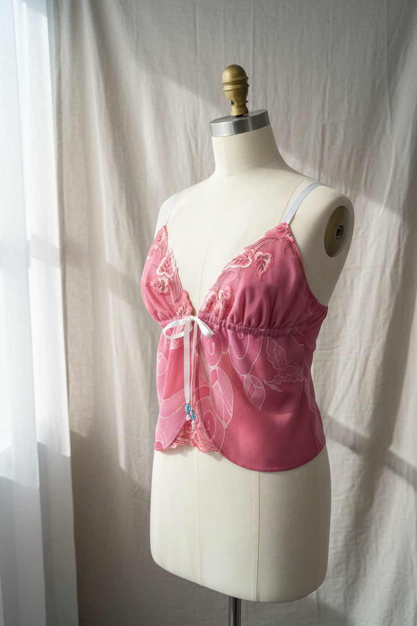 Pink embroidered bra on a mannequin against a plain background