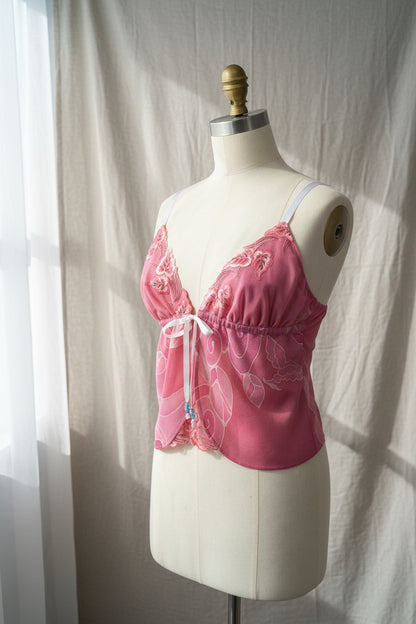 Pink embroidered bra on a mannequin against a plain background