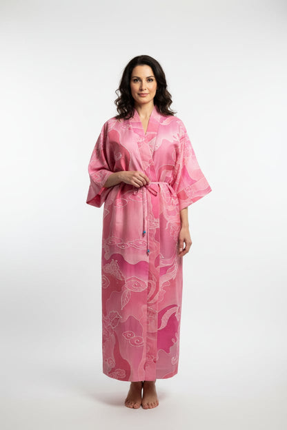 Woman wearing a pink patterned robe on a white background