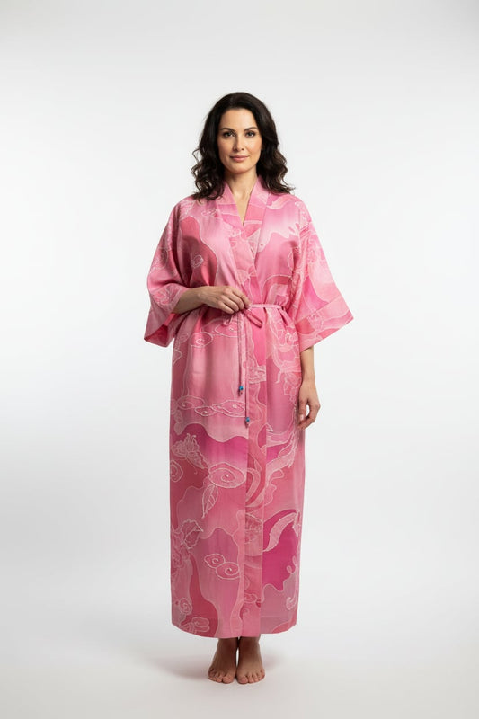 Woman wearing a pink patterned robe on a white background