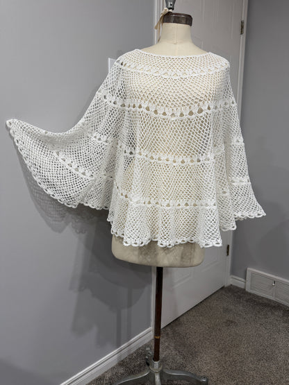 White lace garment on a mannequin against a neutral background