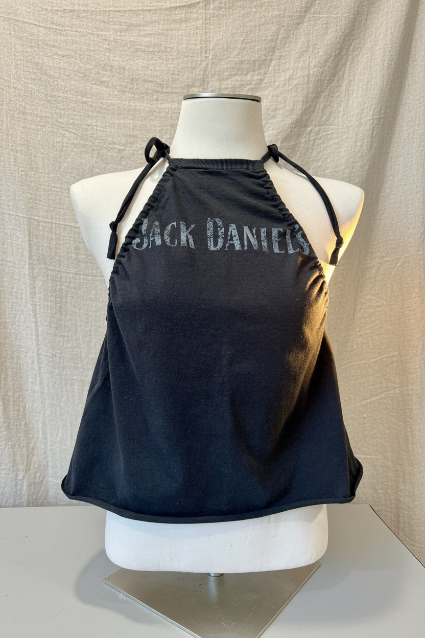Black halter top with 'Black Daniel's' branding on a mannequin against a beige background