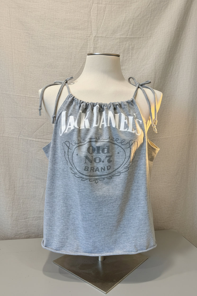Gray tank top with Jack Daniel's branding on a mannequin against a decorative background.