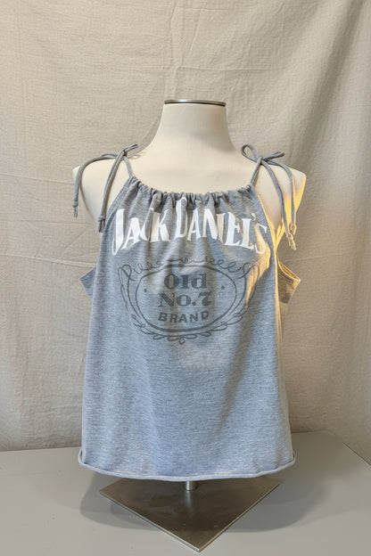 Gray tank top with Jack Daniel's branding on a mannequin against a decorative background.