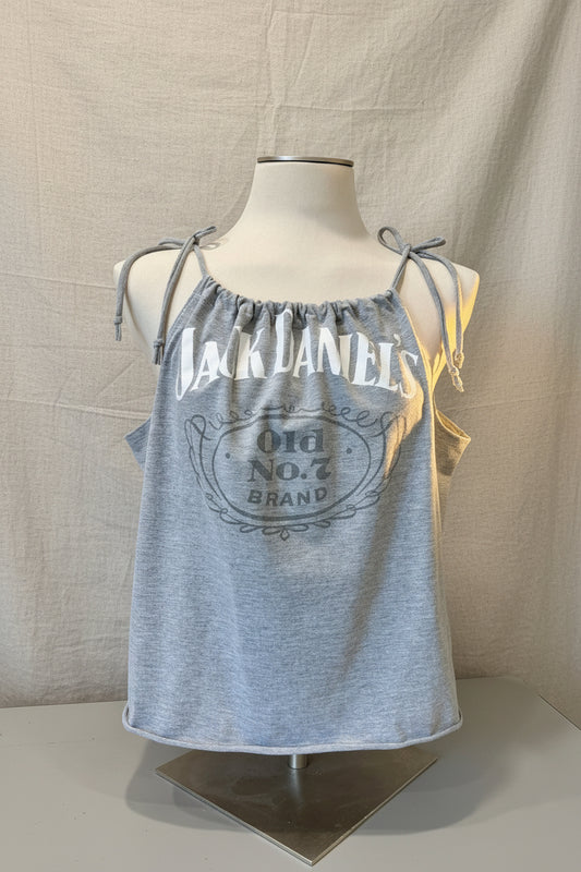 Gray tank top with Jack Daniel's branding on a mannequin against a decorative background.