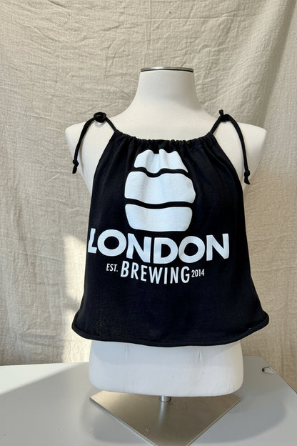Black tank top with 'London Brewing' logo on a mannequin against a beige background