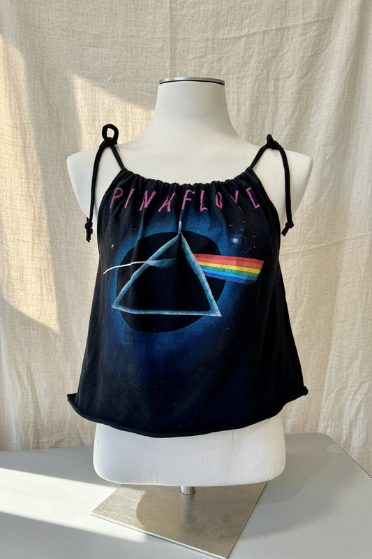 Black tank top with Pink Floyd design on a mannequin against a beige curtain background