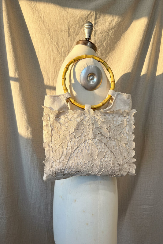 Vintage-style purse with lace  on a white background