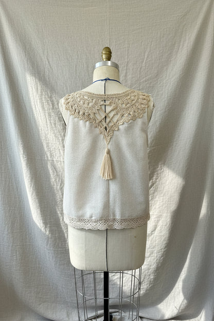 Vintage-style sleeveless top with lace details on a mannequin against a plain background