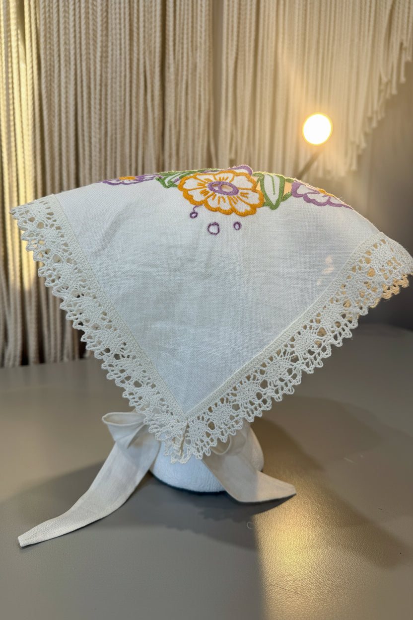 Back View, One-of-two embroidered linen head scarf made from a reclaimed dish towel with floral detail and lace trim. 
