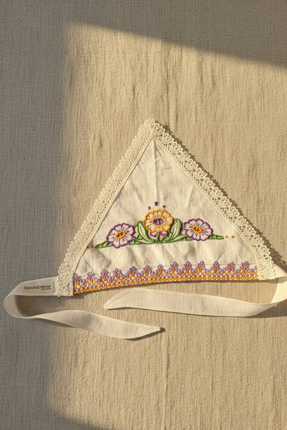 Top View, One-of-two embroidered linen head scarf made from a reclaimed dish towel with floral detail and lace trim. 