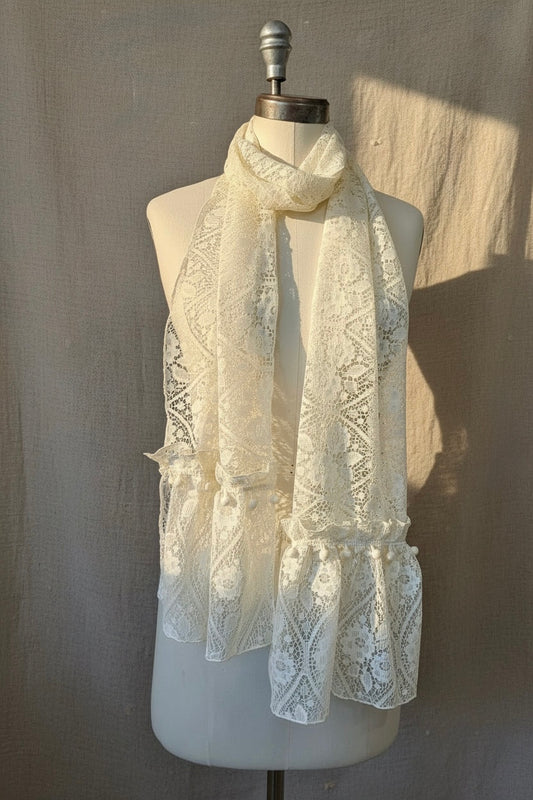 White lace scarf on a mannequin against a neutral background
