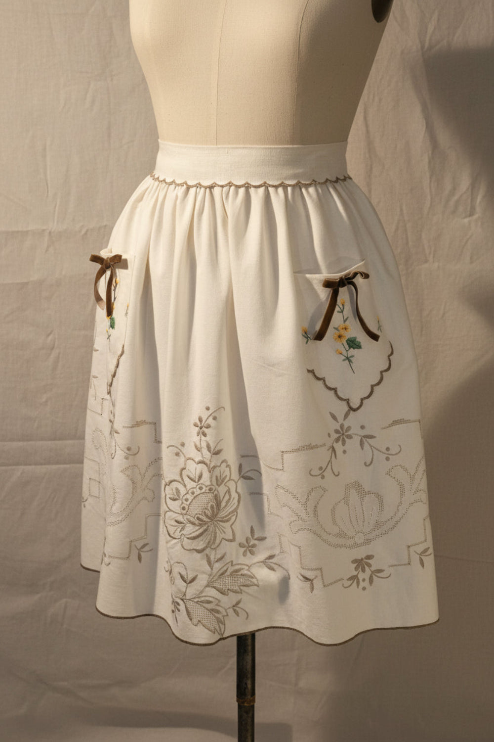 Ivory apron with with floral embroidery on 