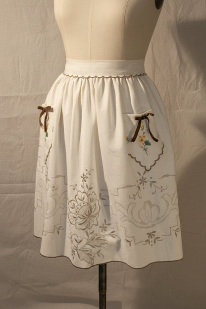 Ivory apron with with floral embroidery on 