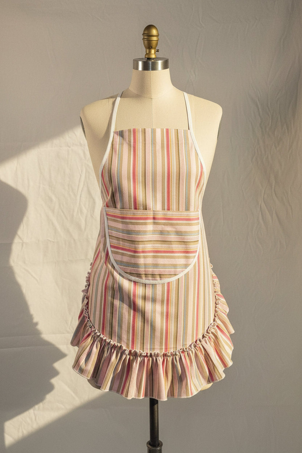 Striped apron on a mannequin against a plain background